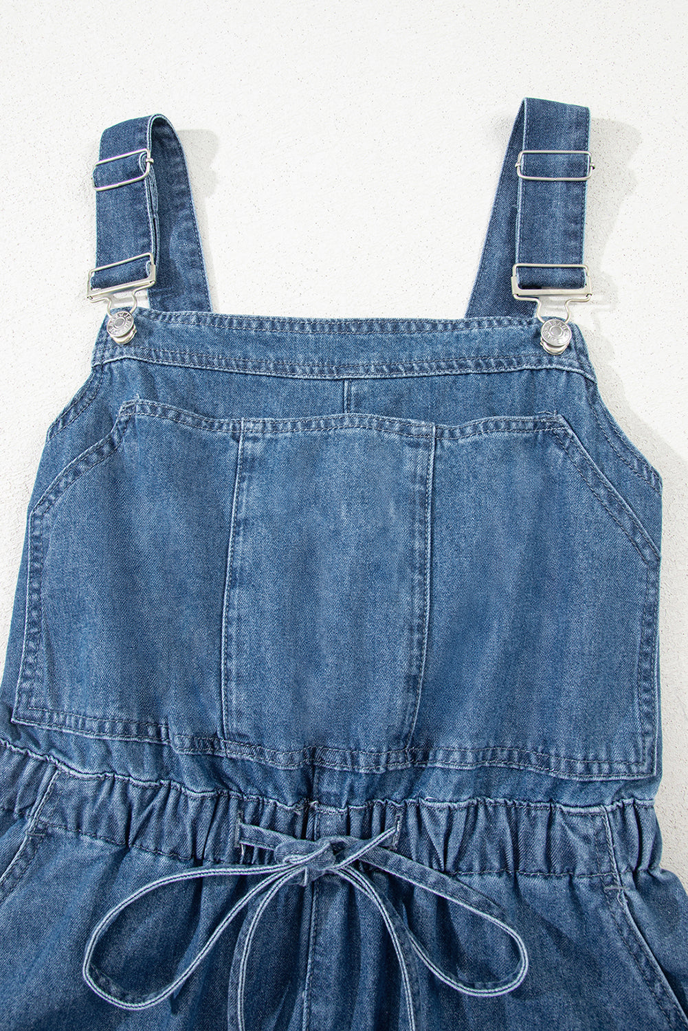Sky Blue Buckle Straps Bib Style Drawstring Tied Backless Flared Denim Romper